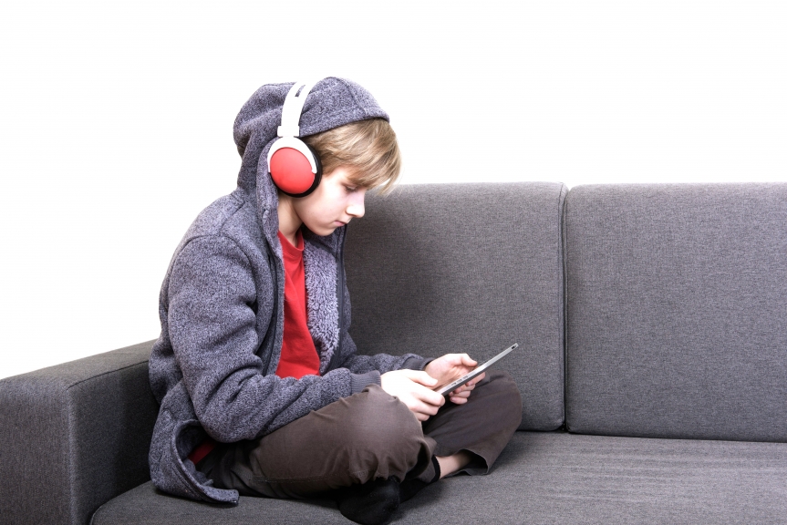 boy with a digital tablet sitting on the couch
